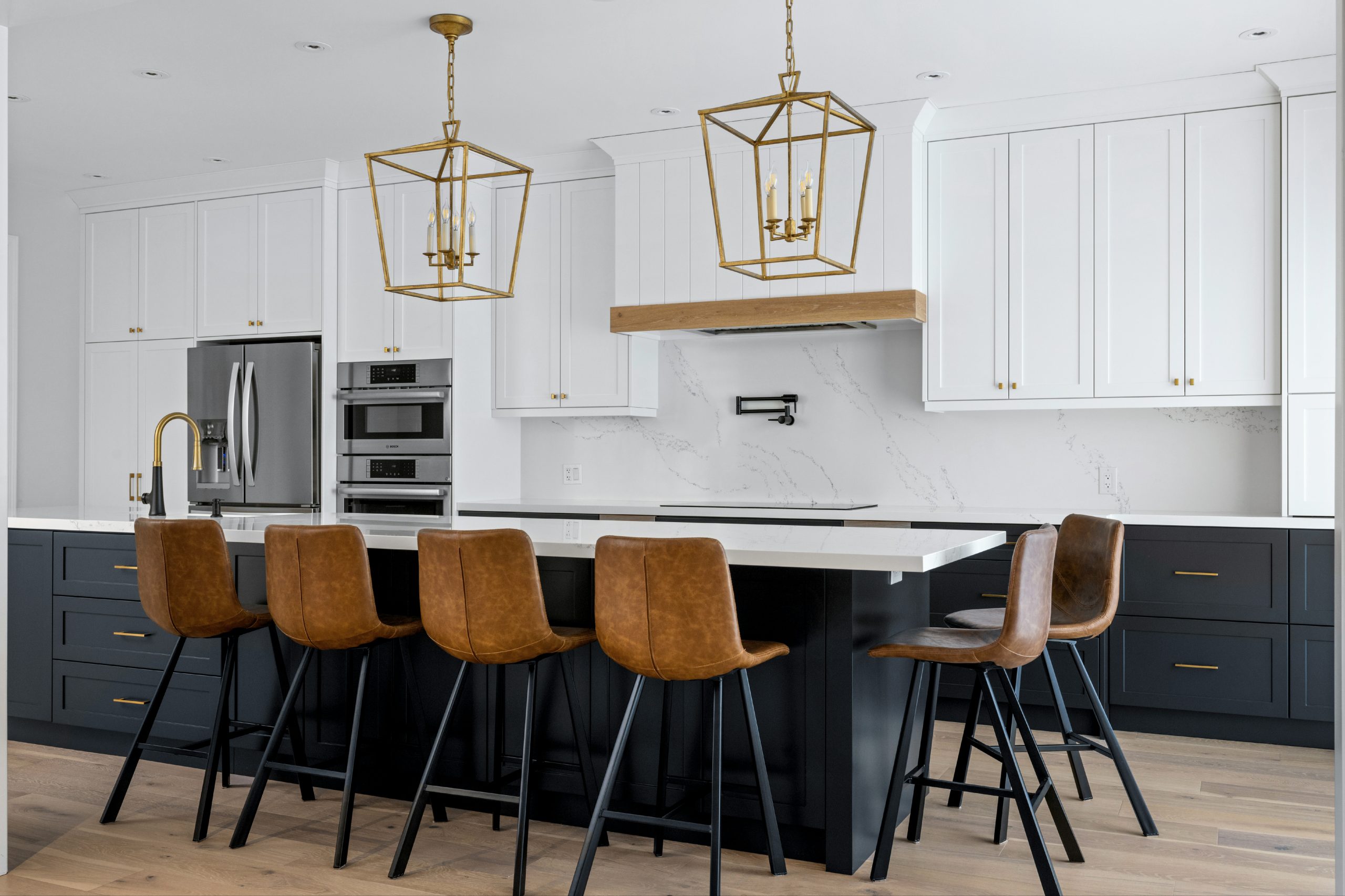 Boughton Crescent kitchen with a navy island, brass lanterns and leather stools