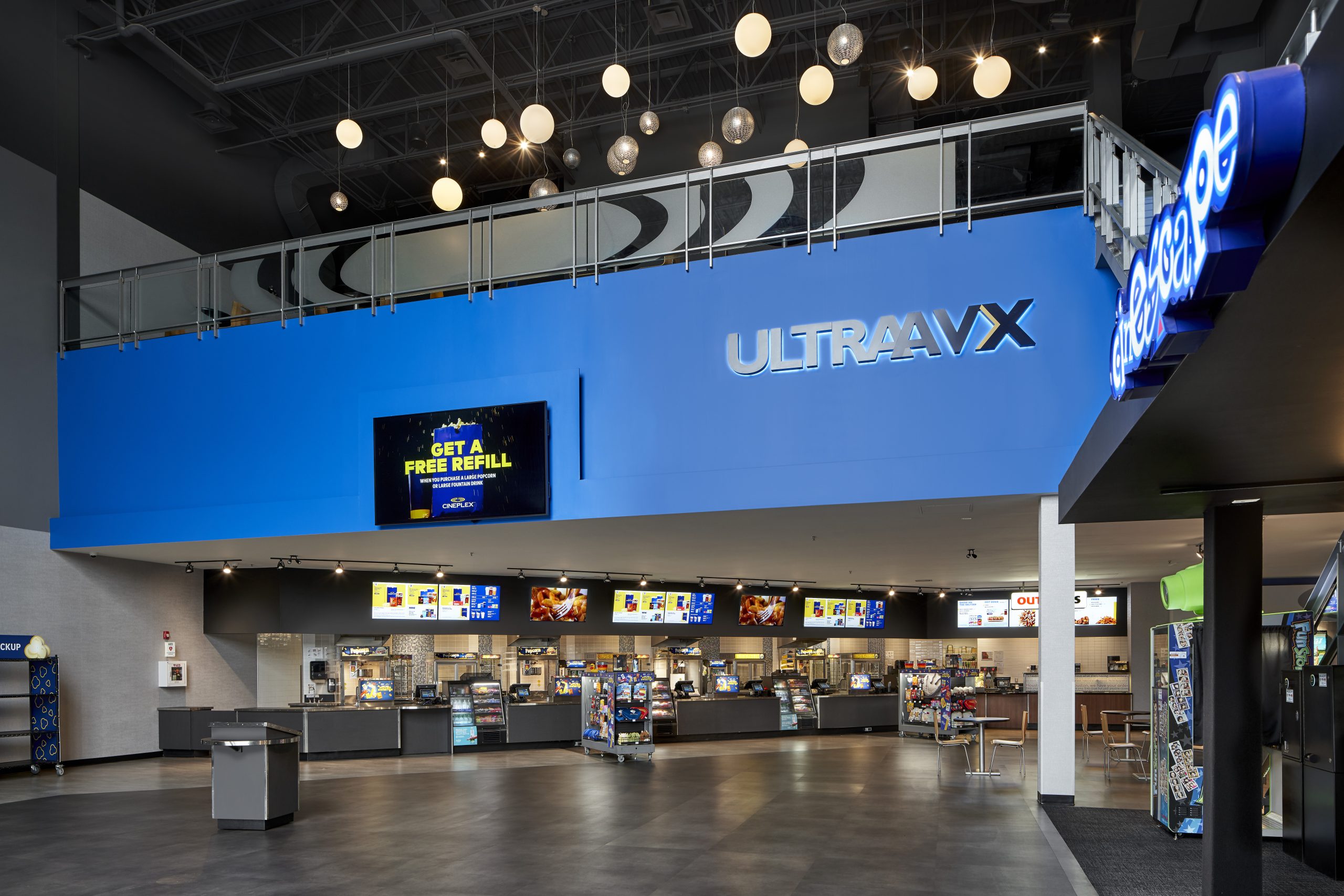 Cineplex Pergola Commons lobby with illuminated UltraAVX signage and concession counter