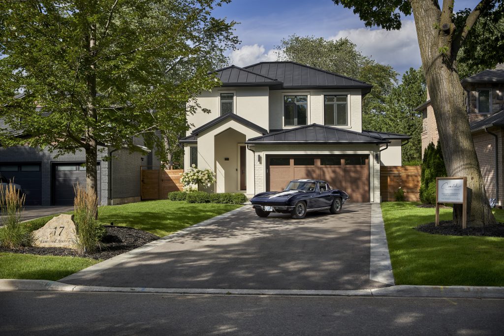 Front exterior of the Elmwood Avenue home with a car in the driveway