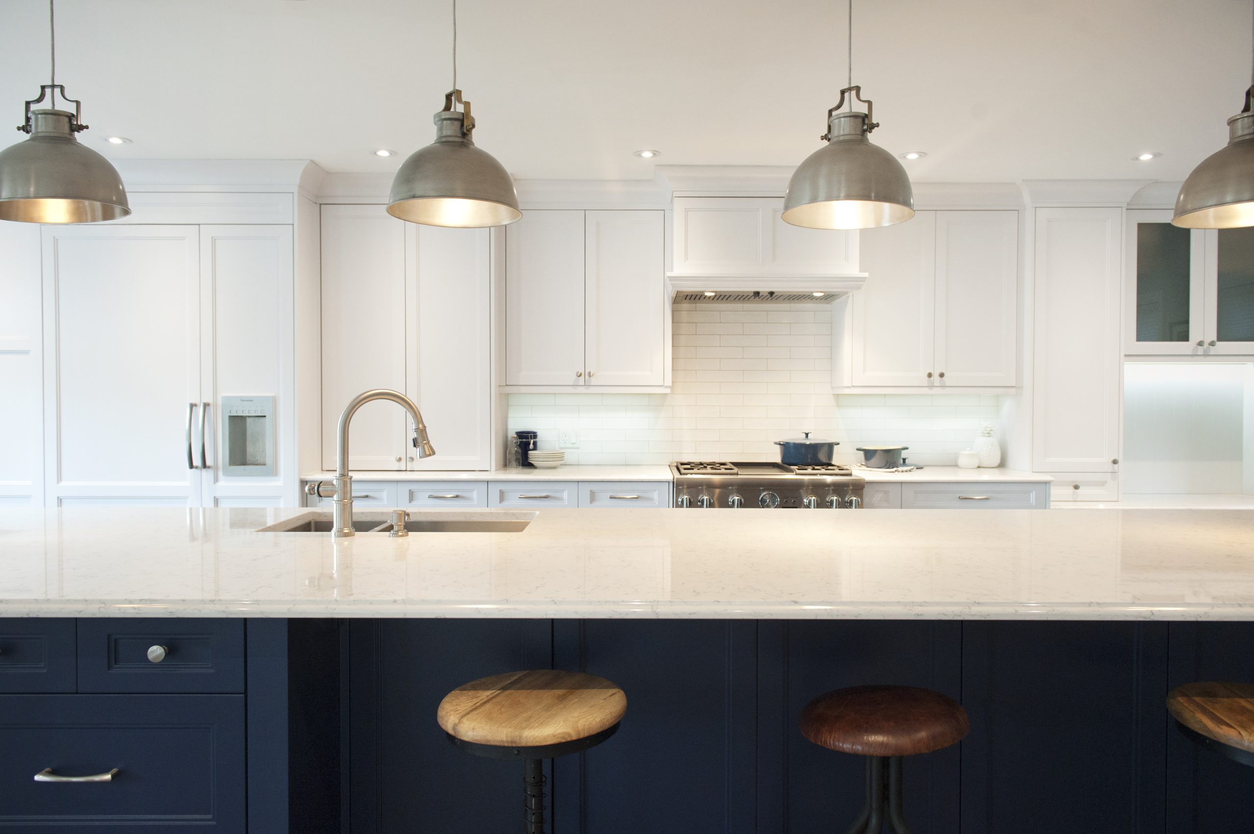 Colchester Drive kitchen with a navy island and industrial pendant lights