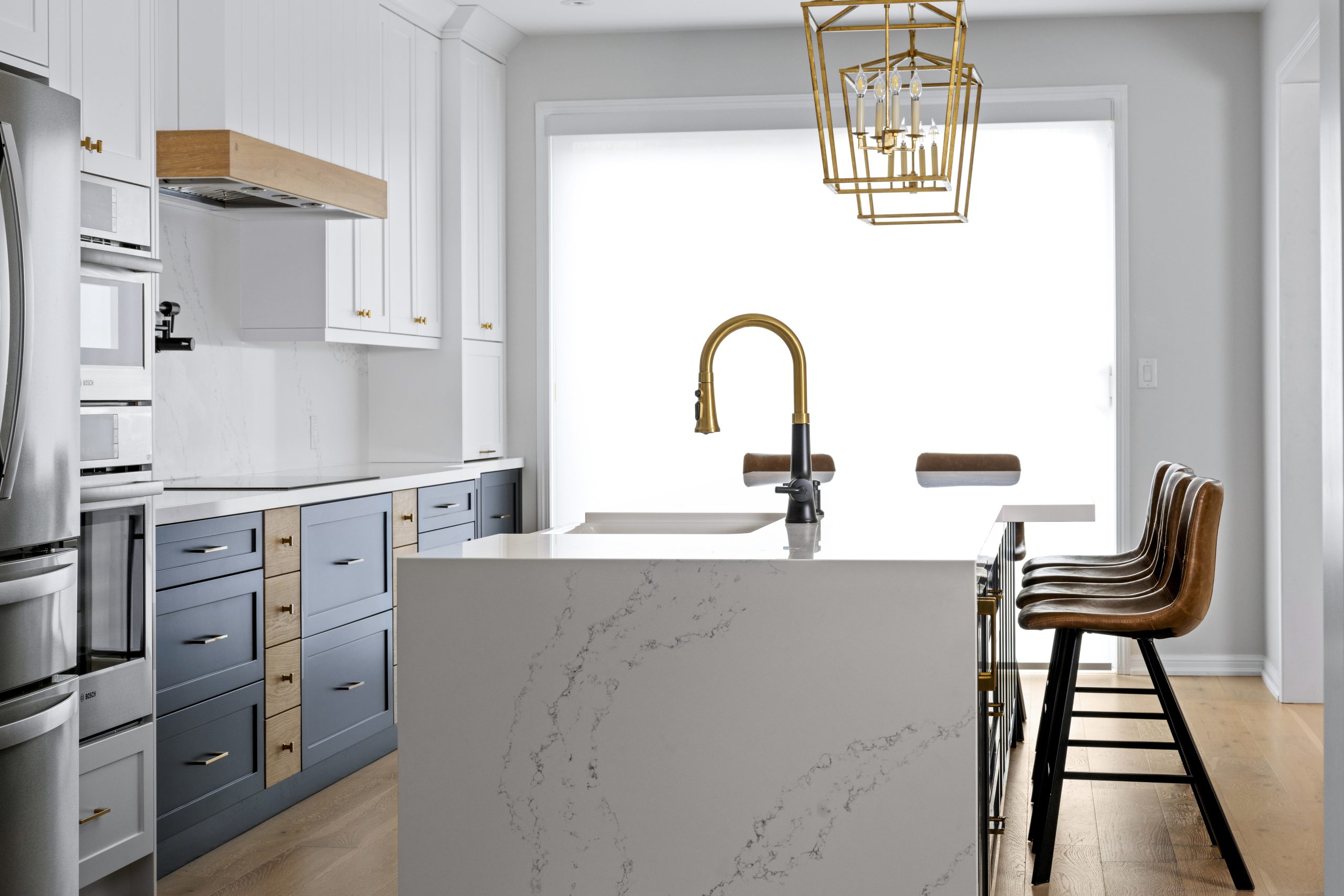 Boughton Crescent island with a quartz waterfall counter and a brass faucet