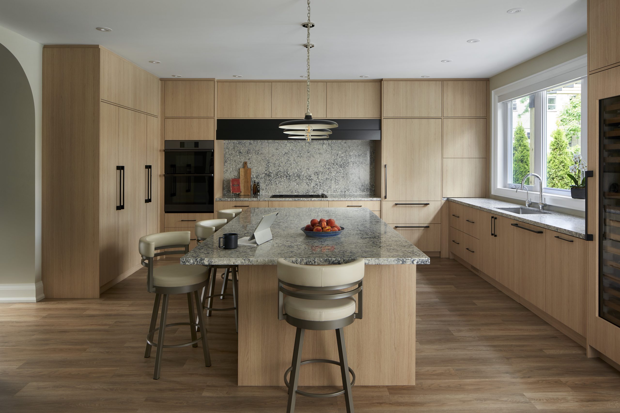 Elmwood Avenue kitchen with oak cabinetry and a stone island