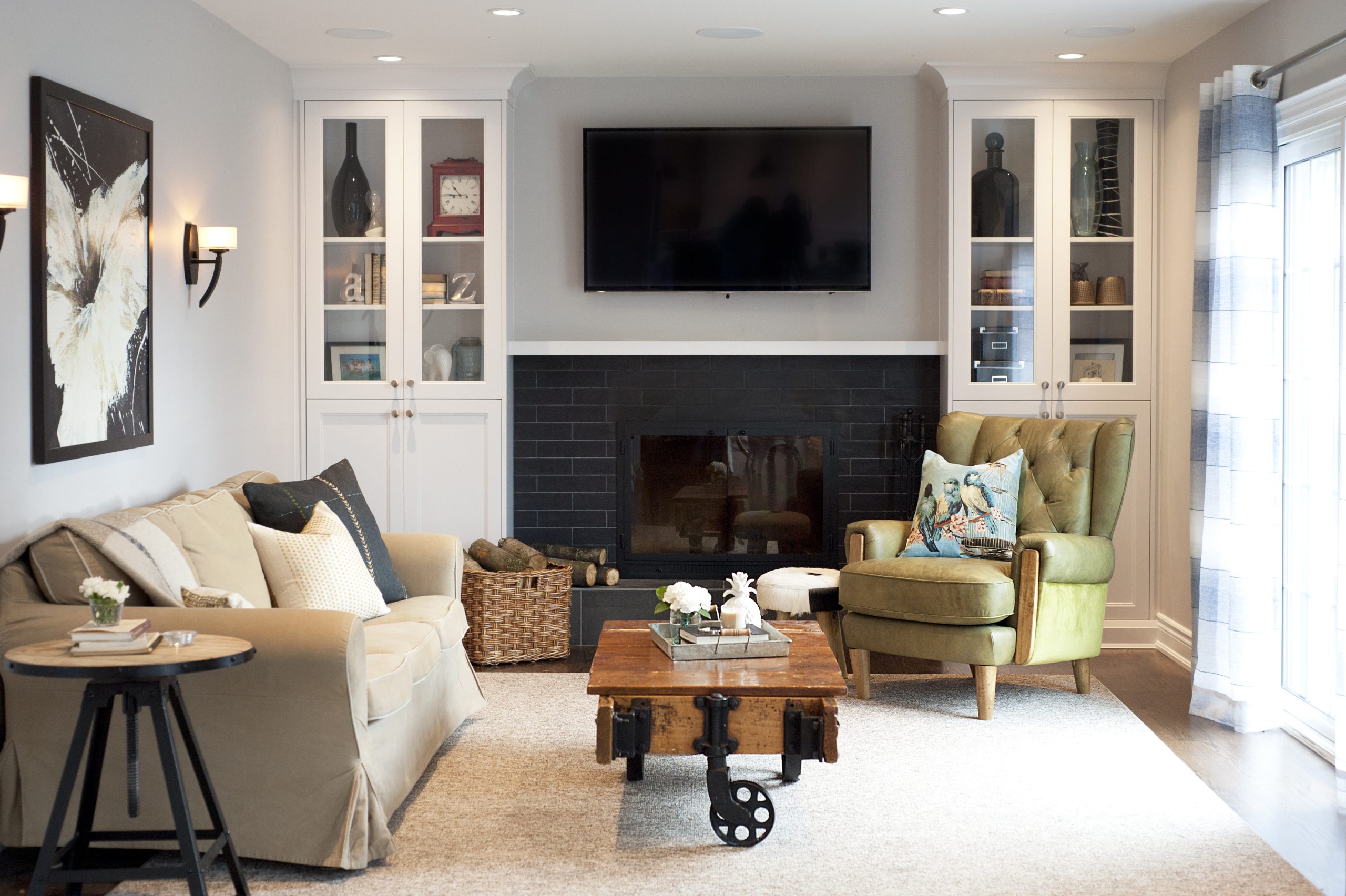 Living room with a painted brick fireplace and built-in cabinetry