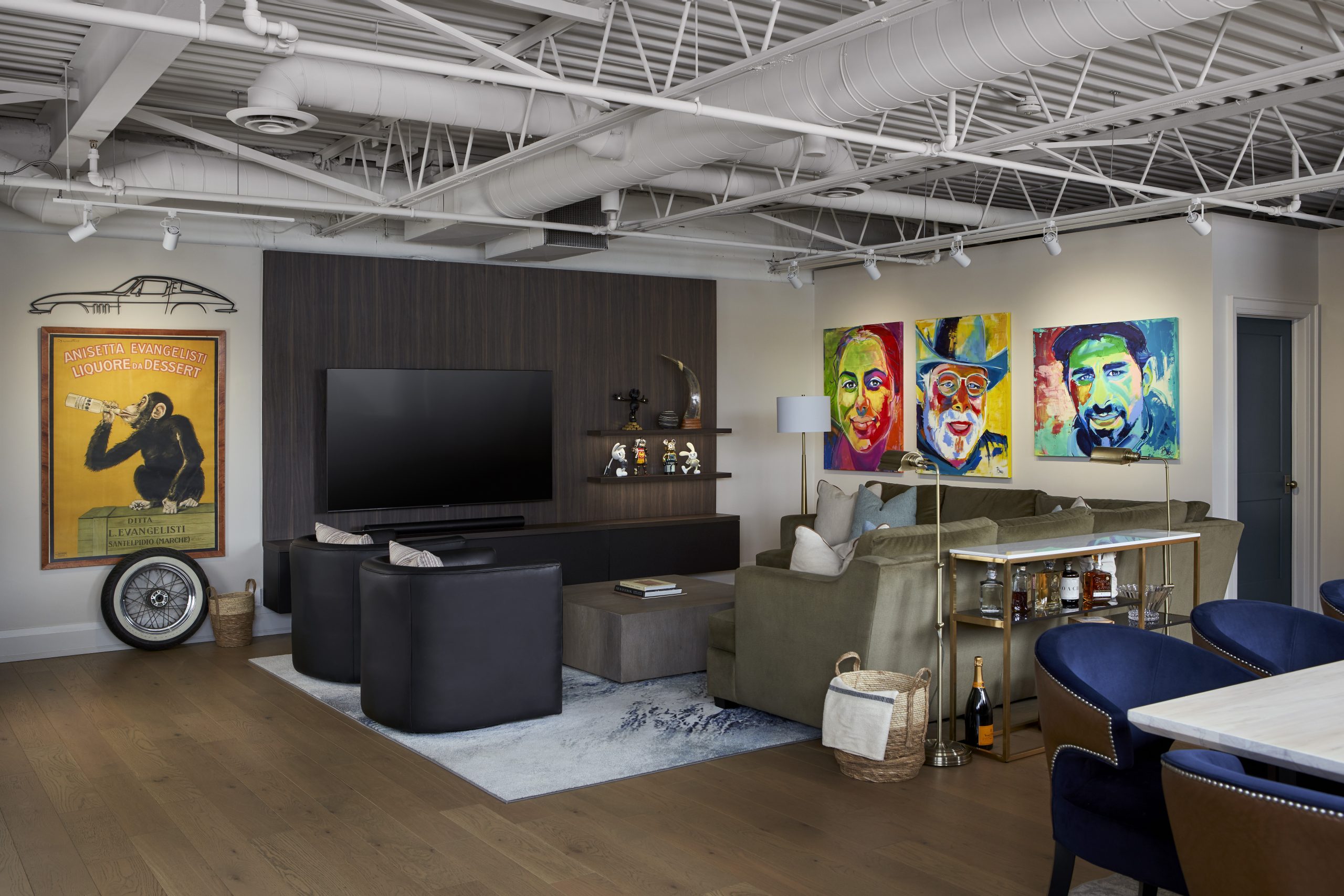 Signet Drive lounge with pop-art portraits, an olive sofa and a media wall